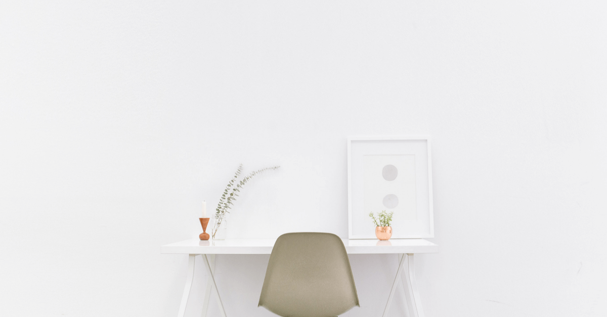 Minimalist home office desk with a chair.